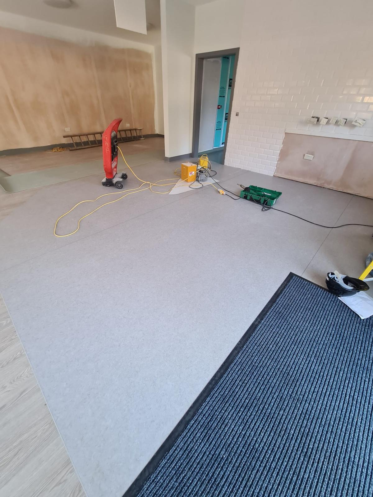 Commercial vinyl flooring installation with entrance matting