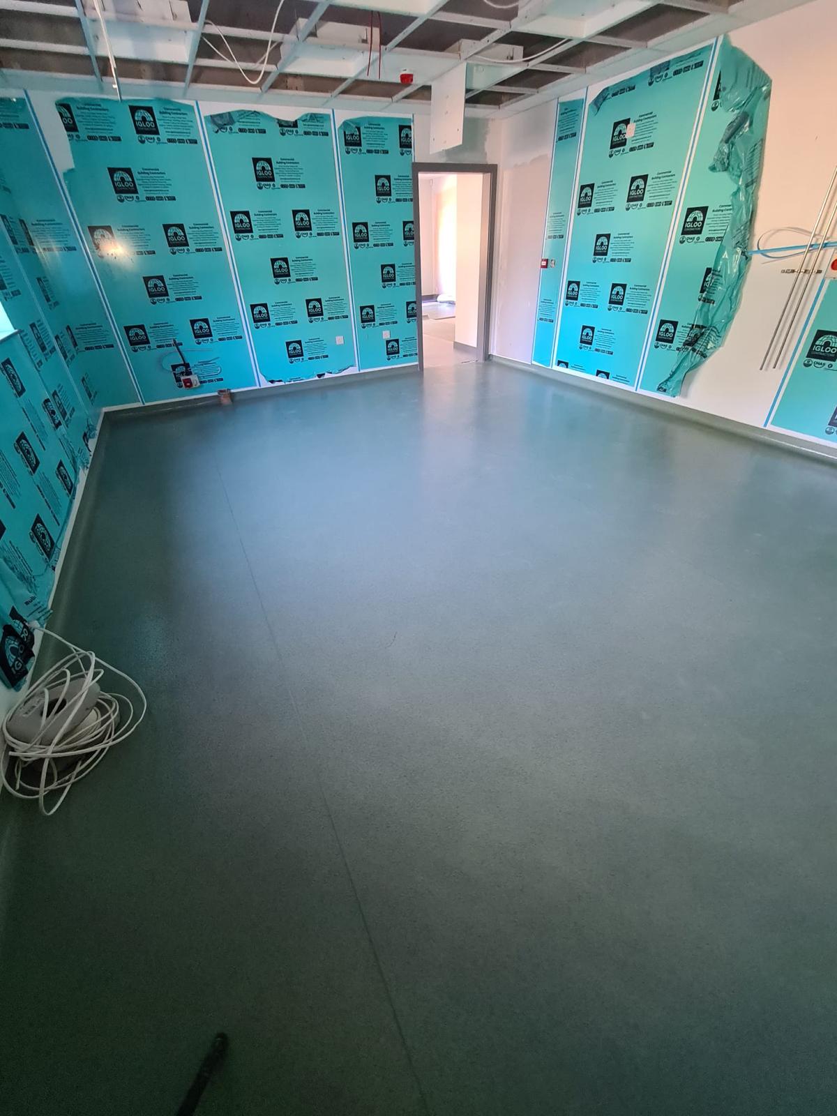 Commercial safety floor installation in new build with protection boards