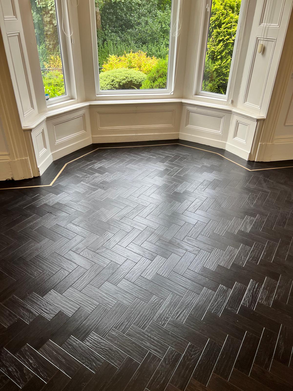 Herringbone LVT floor installed in bay window room with border detail